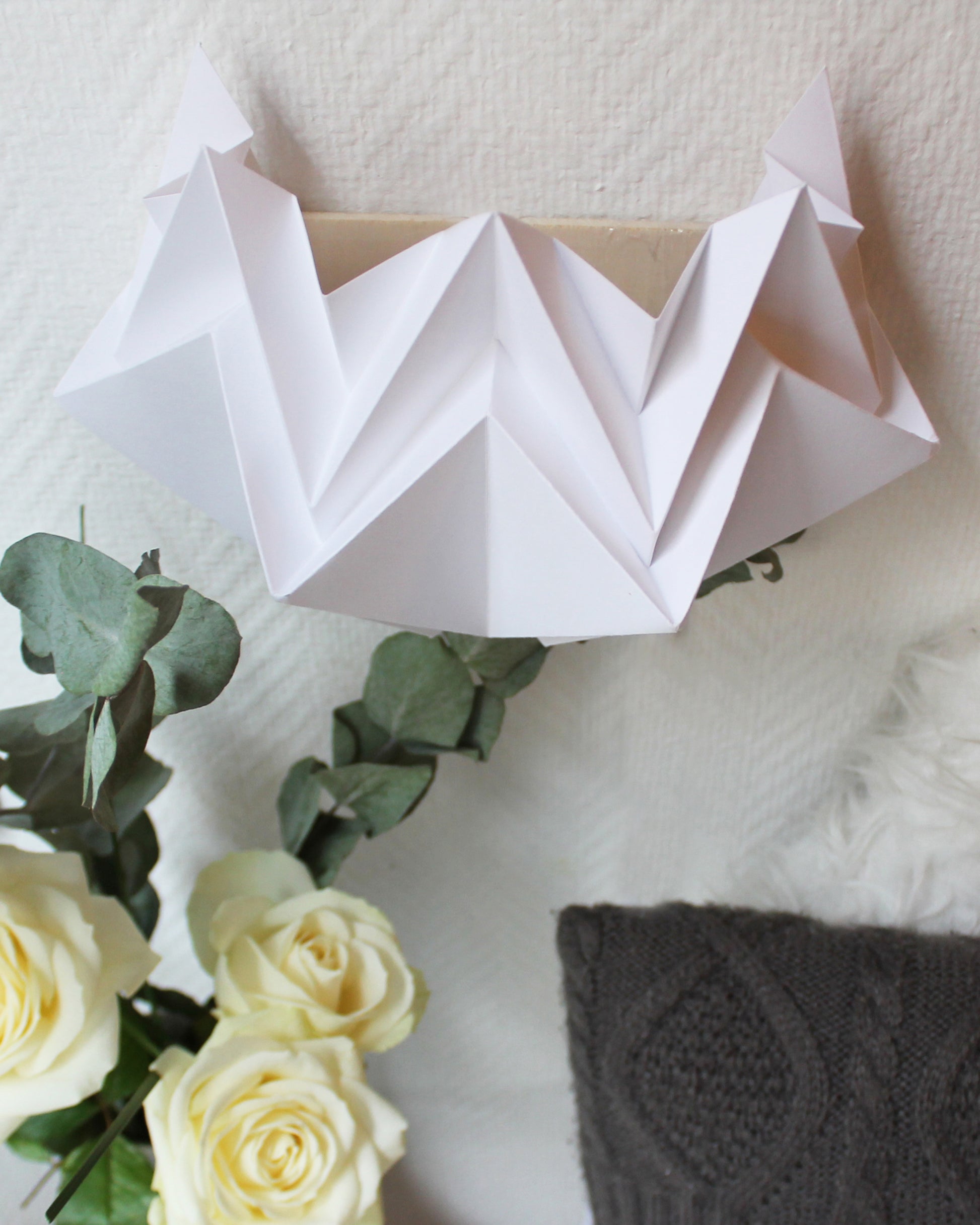 detail white origami sconce